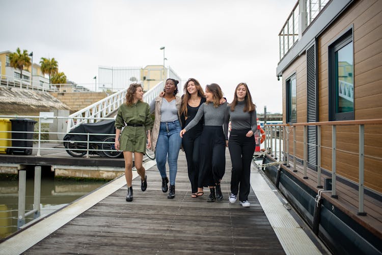 Group Of Women Walking On Boardwalk