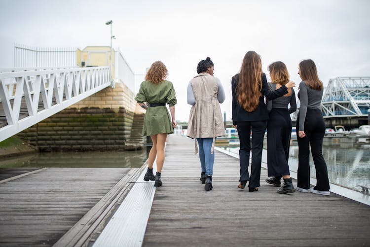 Women Walking On A Wooden Deck