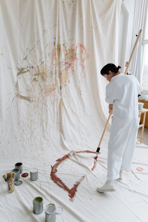 Woman Creating Contemporary Painting on White Fabric 