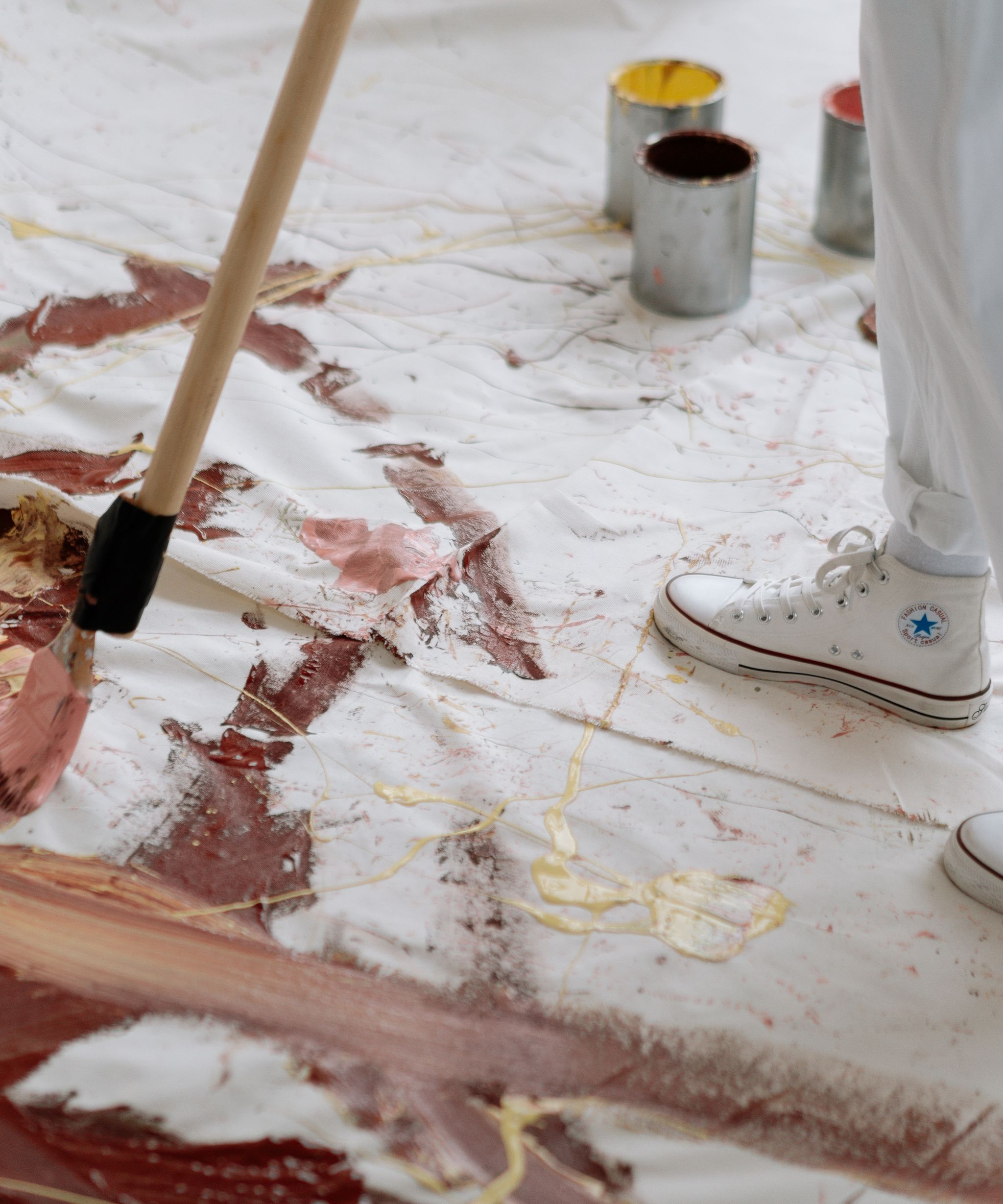 Artist working on a painting in a studio