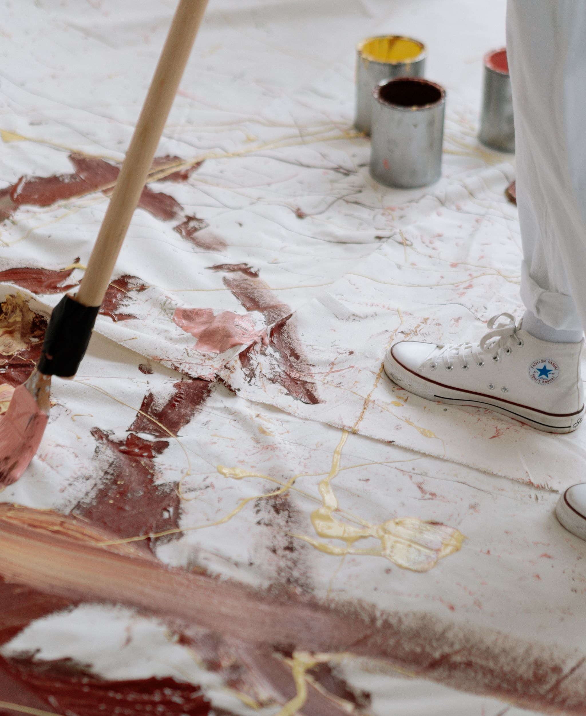 Artist working on a painting in a studio