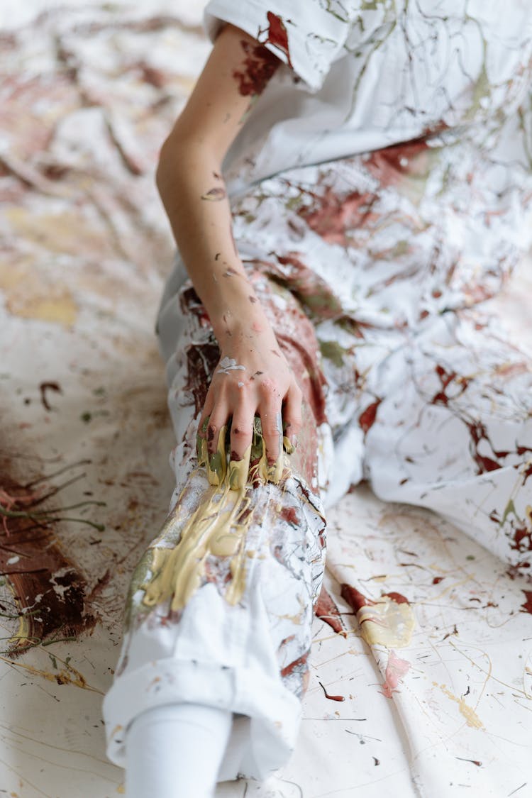 A Person Wearing White Coveralls With Paint Splatter