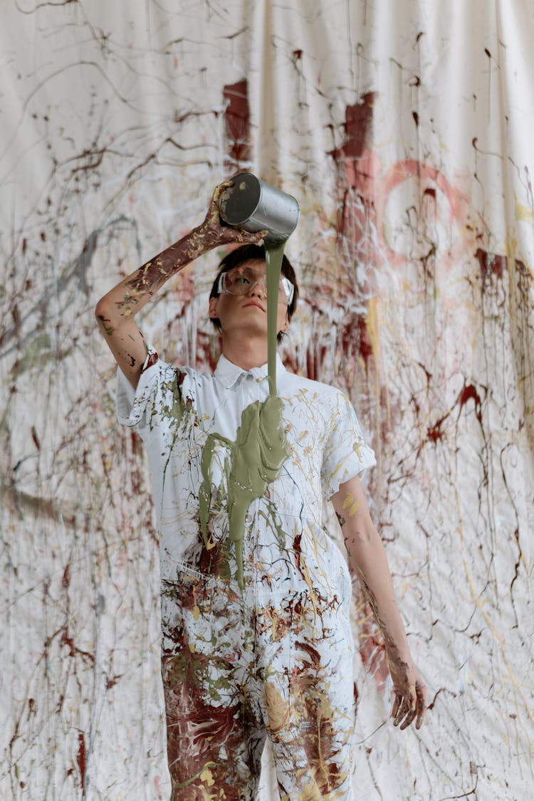 A Man Pouring Paint On His Chest