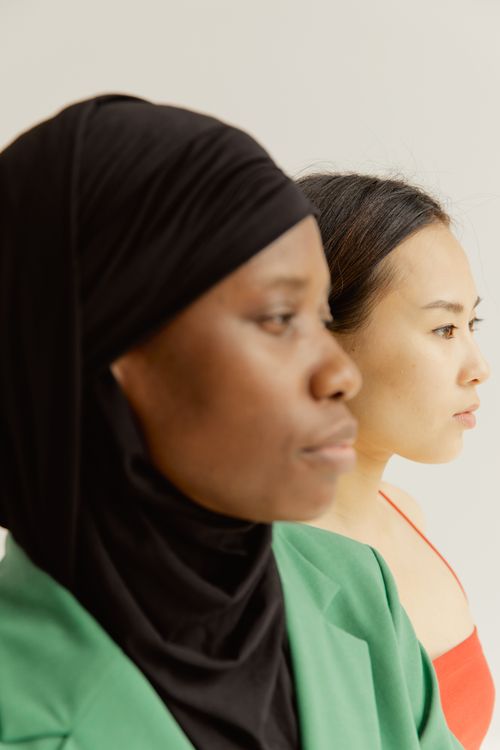Free Two women in cultural attire facing forward, highlighting diversity. Stock Photo
