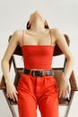 Woman in Red Spaghetti Strap and Red Pants With Black Belt