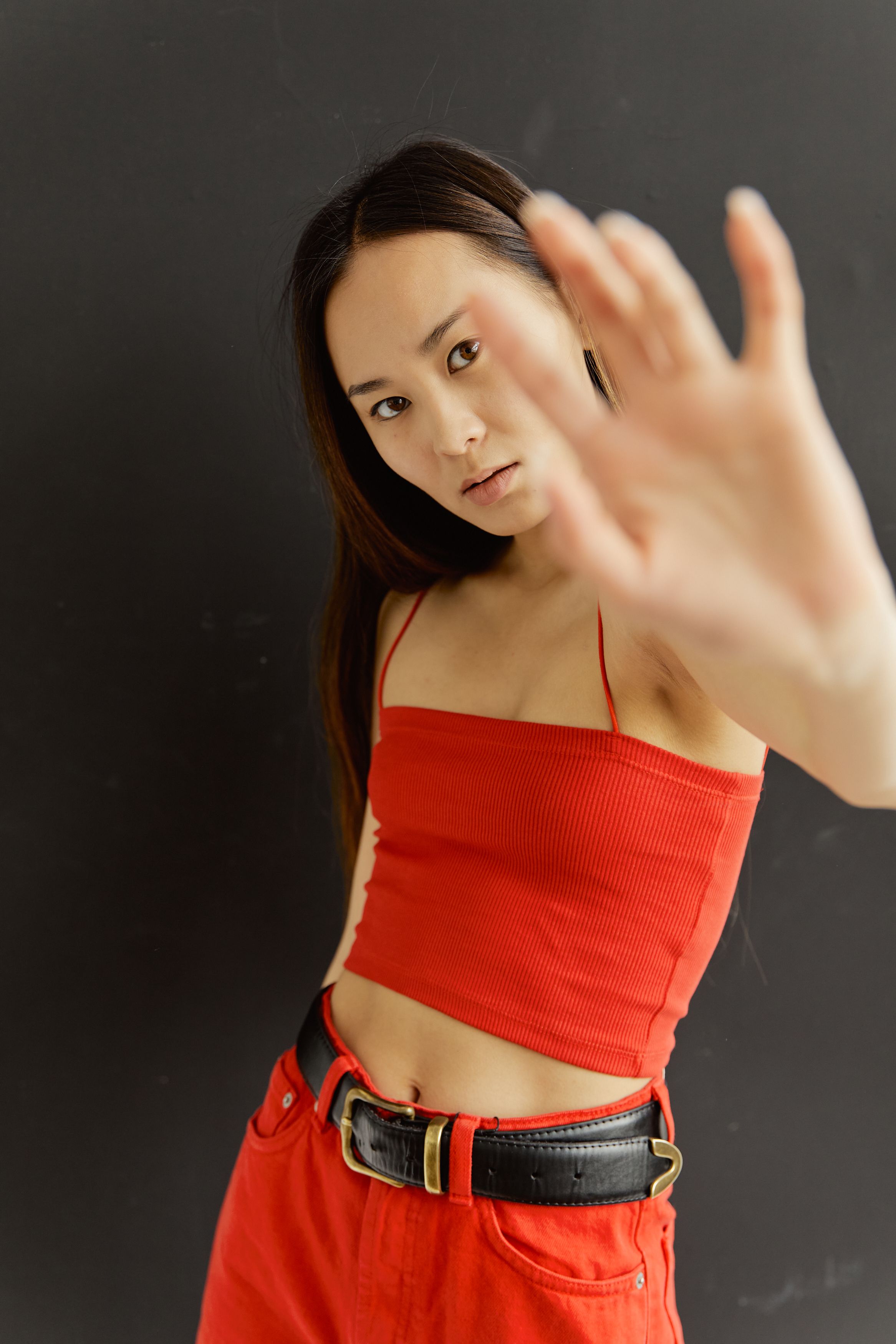 Striking portrait of a young woman in red clothes, exuding fashion and style.