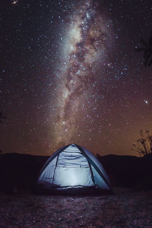Free A serene camping scene with a tent under the captivating Milky Way in a starry night sky. Stock Photo