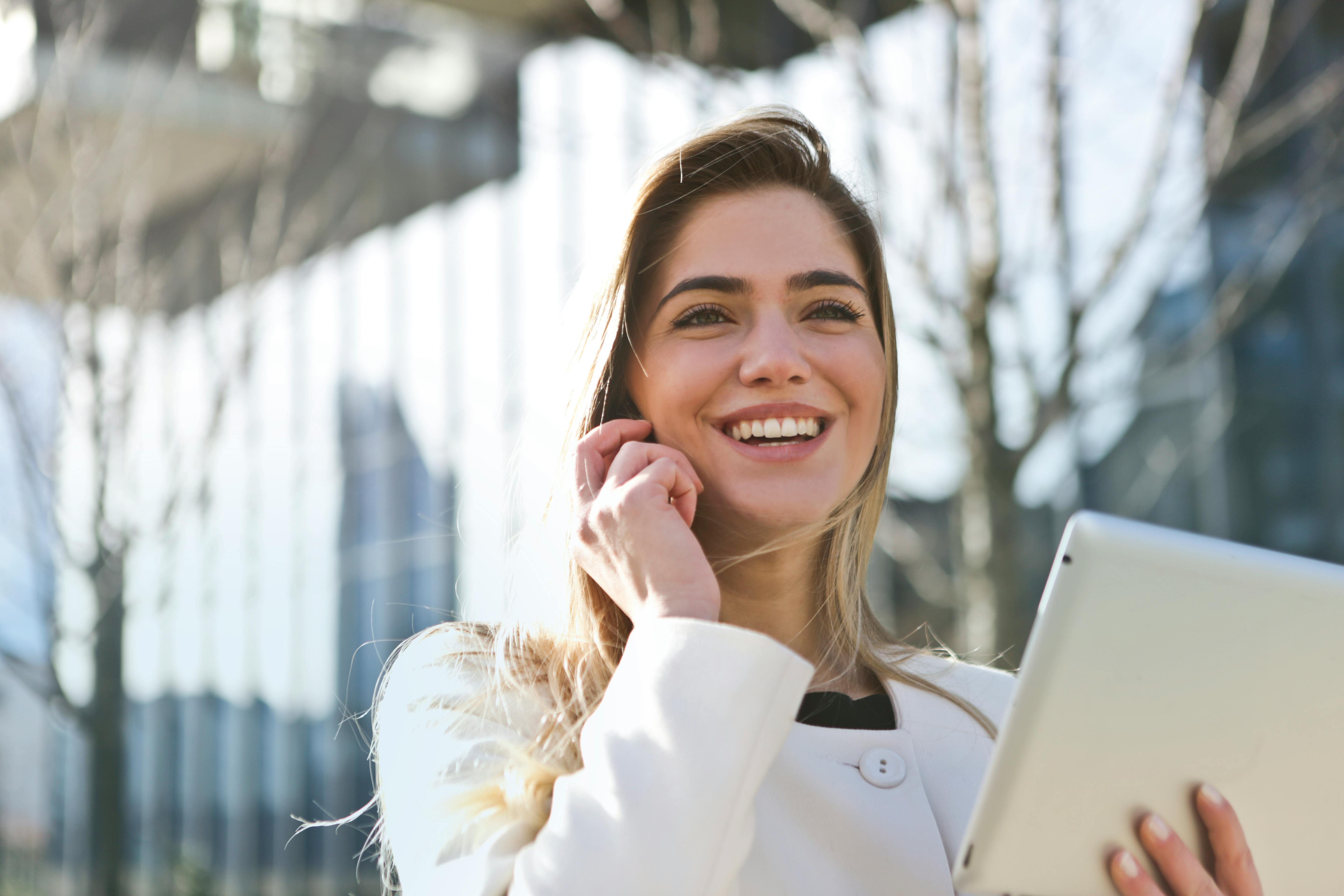 Free Woman In White Blazer Holding Tablet Computer Stock Photo