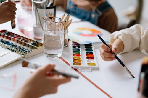 A Group of Kids Holding Paint Brushes