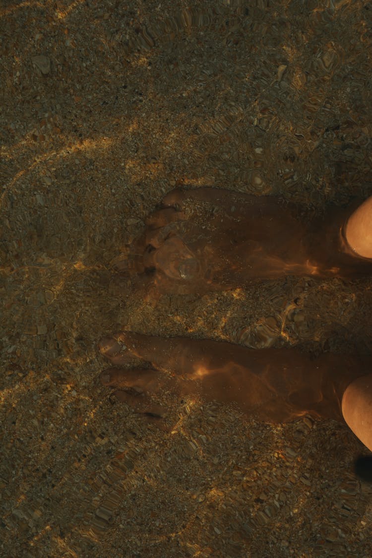 A Person's Feet Underwater