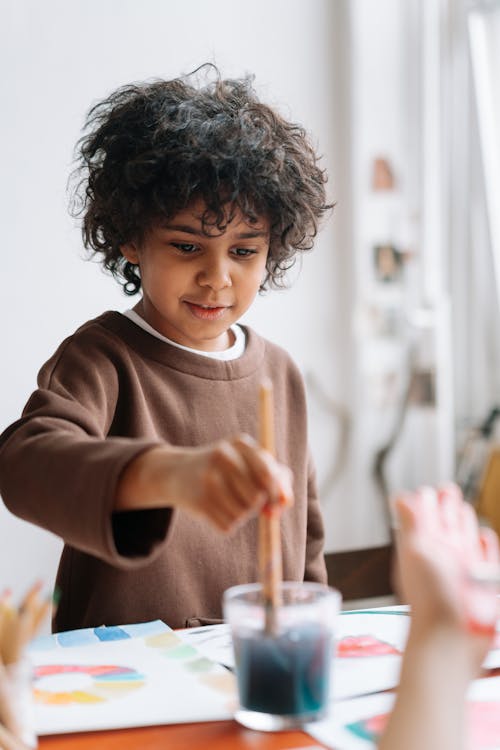 A Boy Holding a Paintbrush