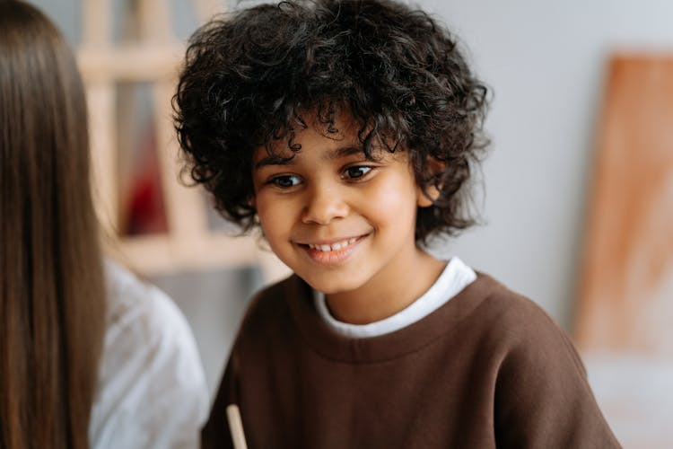 Kid In Brown Shirt Looking Away