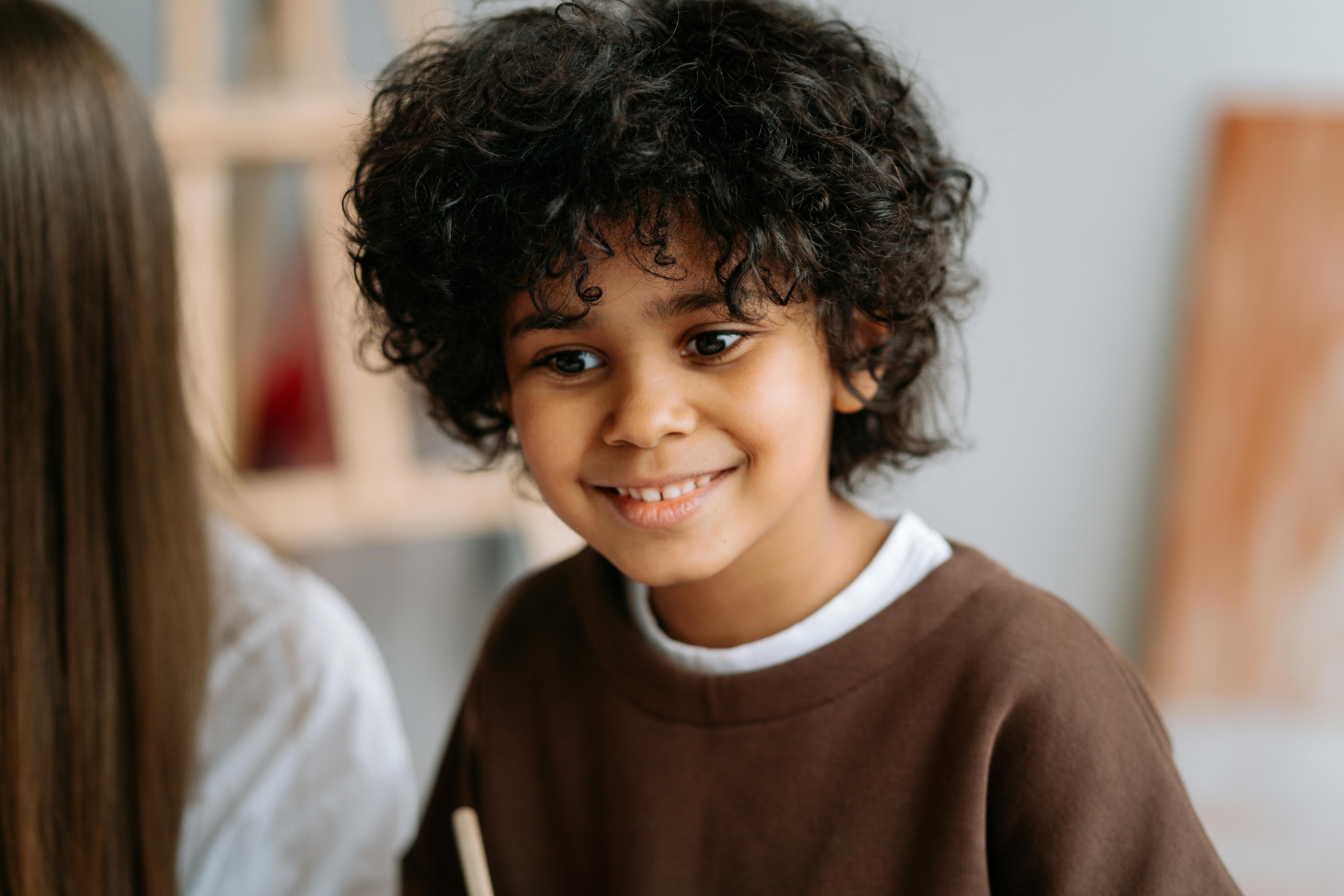A Cute Little Girl with Curly Hair Smiling at the Camera · Free Stock Photo A Cute Little Girl with Curly Hair Smiling at the Camera · Free Stock Photo