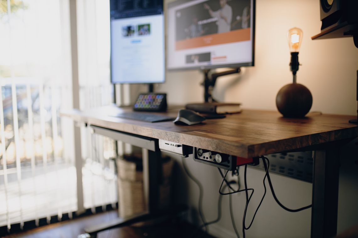 Standing desk with computer in a clean home office workspace