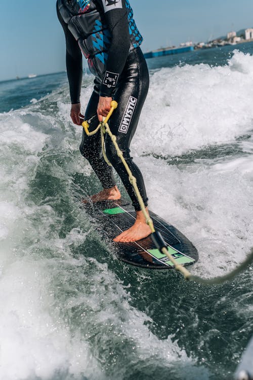 
A Close-Up Shot of a Surfer Holding a Rope