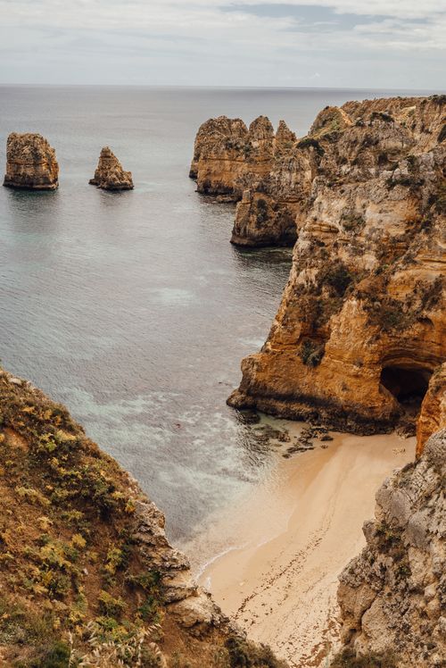 Free Stunning view of rock formations and secluded beach on the Algarve coastline in Portugal. Stock Photo