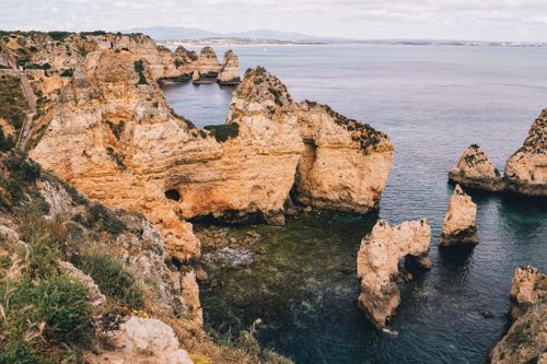 Free Captivating view of the Algarve's stunning rock formations and coastline, showcasing nature's artistry. Stock Photo
