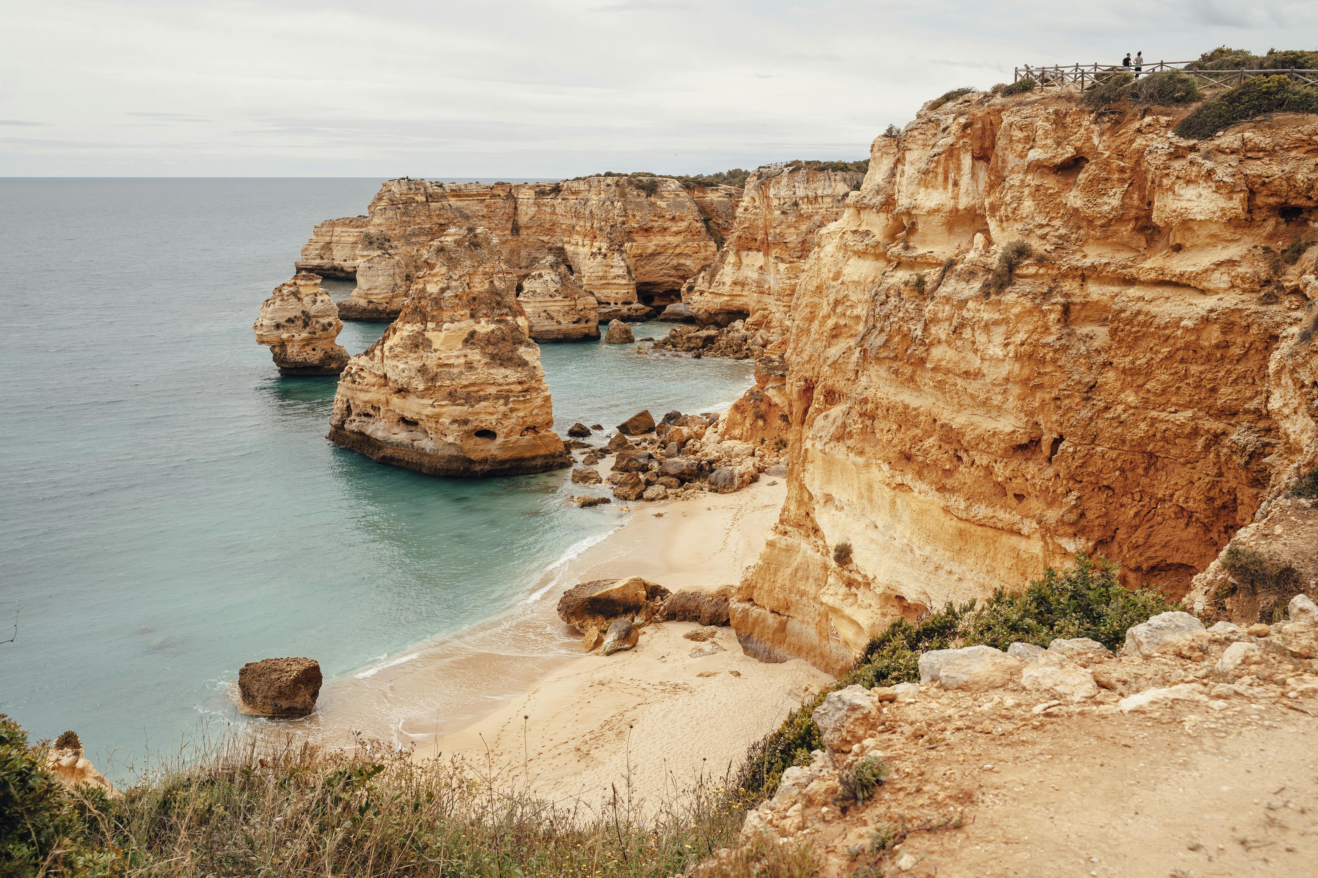 brown rock formation near body of water