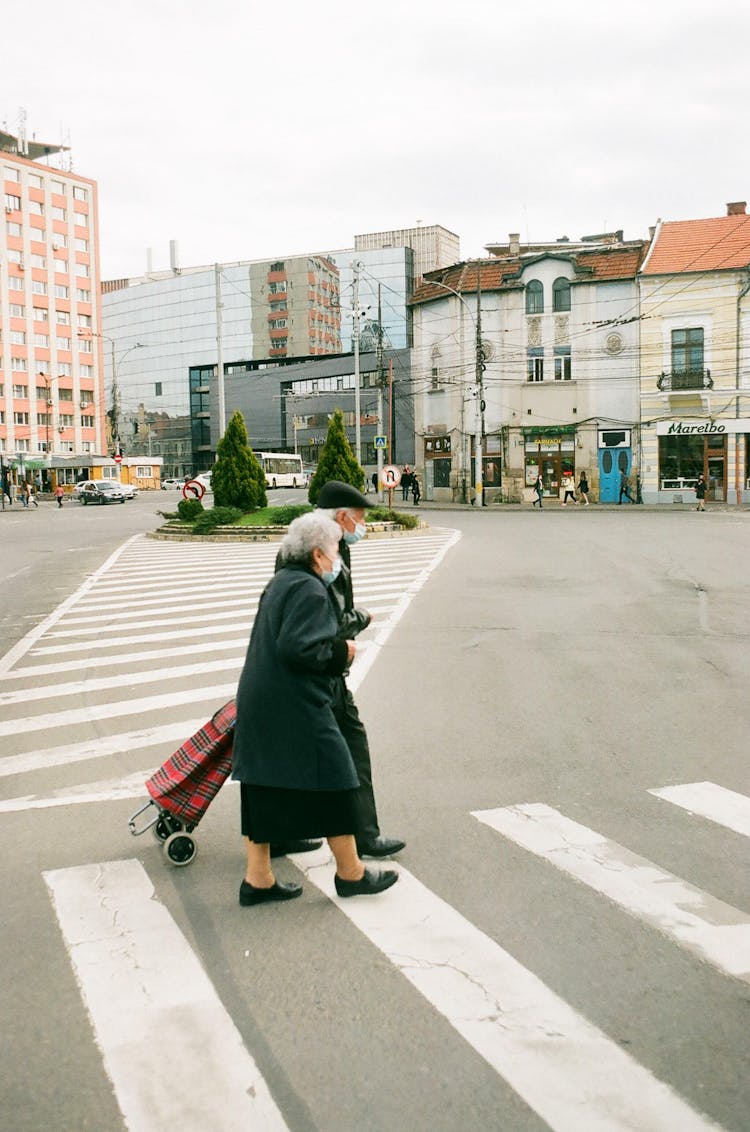 An Elderly Couple Crossing The Road