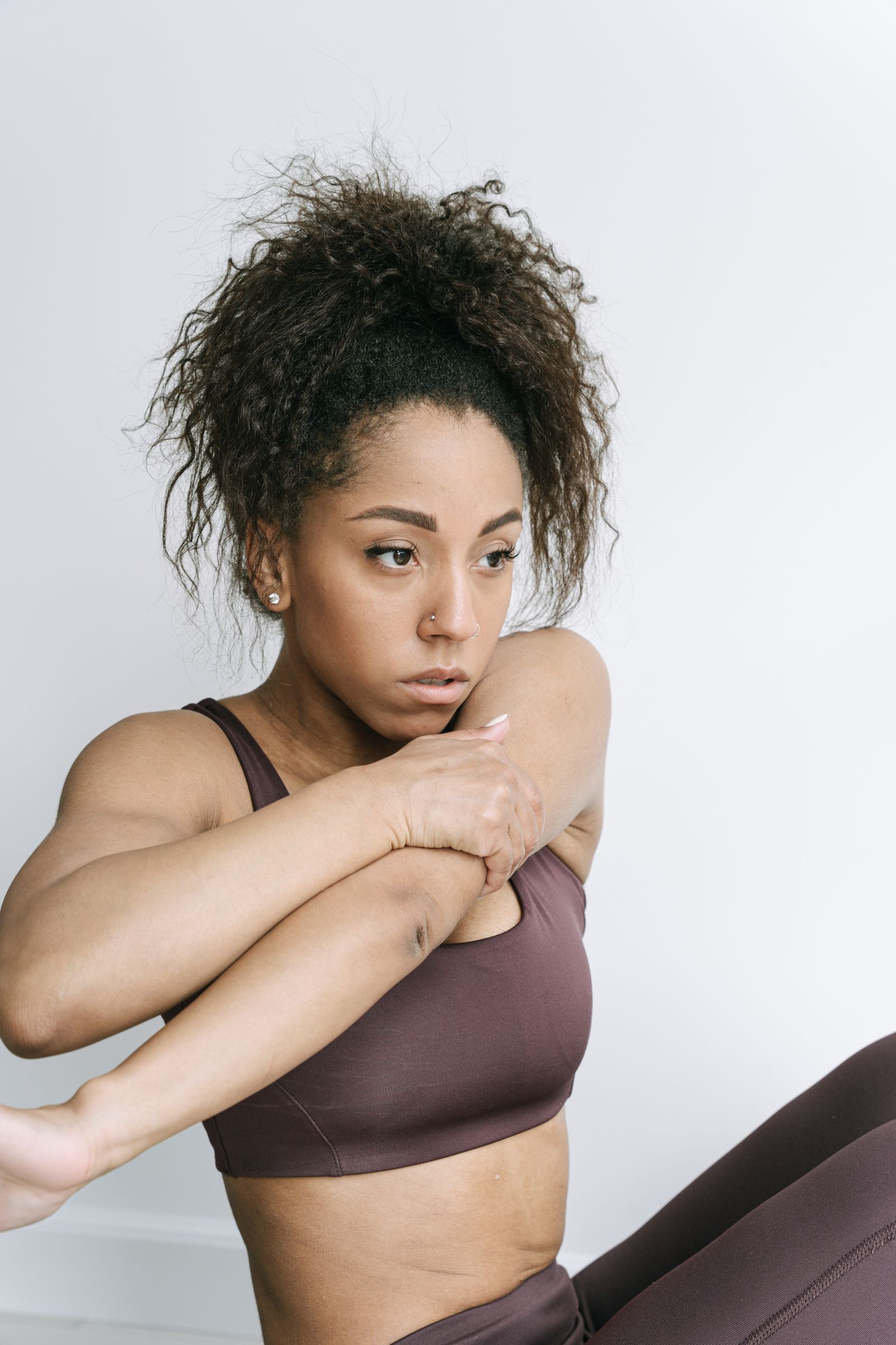 Individual pace in yoga practice Woman in activewear stretching during a home yoga practice