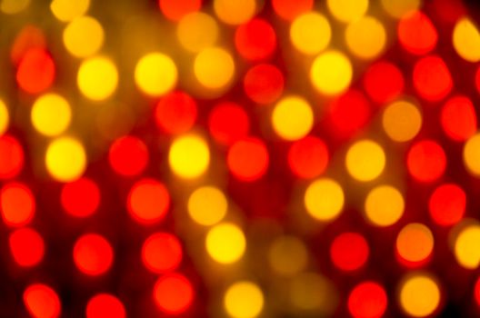 Abstract image showcasing a vibrant red and yellow bokeh light pattern.
