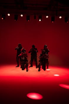 Sci-fi troopers in dramatic red lighting on a stage, creating an intense cinematic atmosphere.