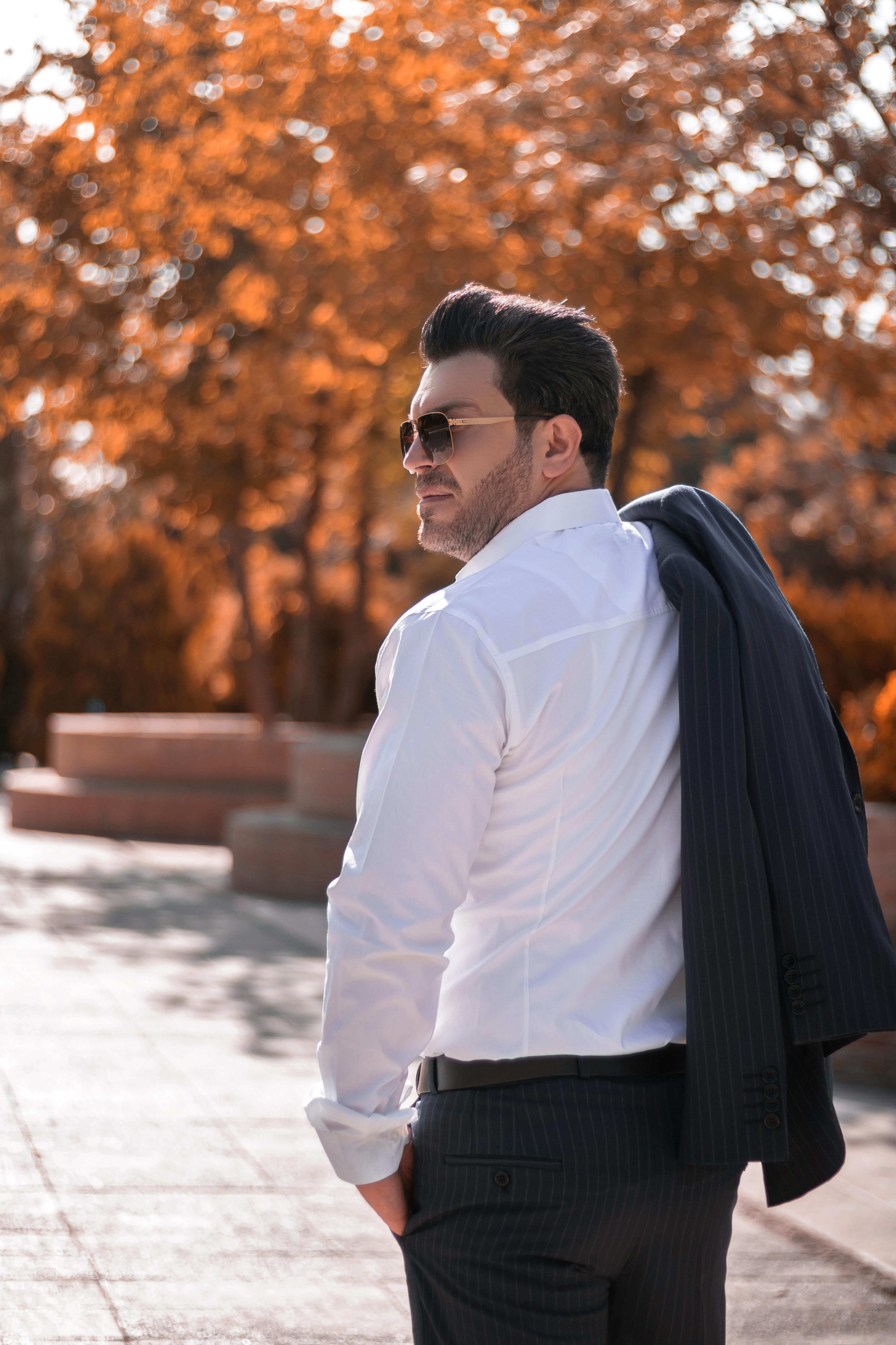 Man in black crew neck t-shirt and brown pants standing beside