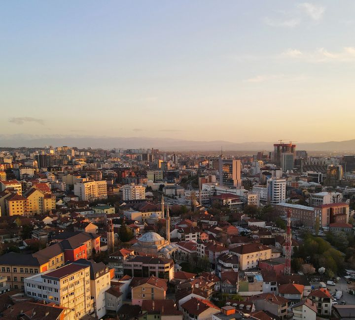 Pristina - Vibrant city street with local shops and cafes