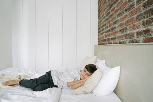 Free A Boy Lying on the Bed  Stock Photo