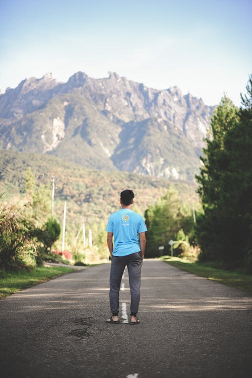 Free Man Standing on Road Stock Photo