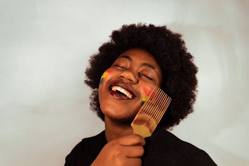 A Woman Holding Hair Comb