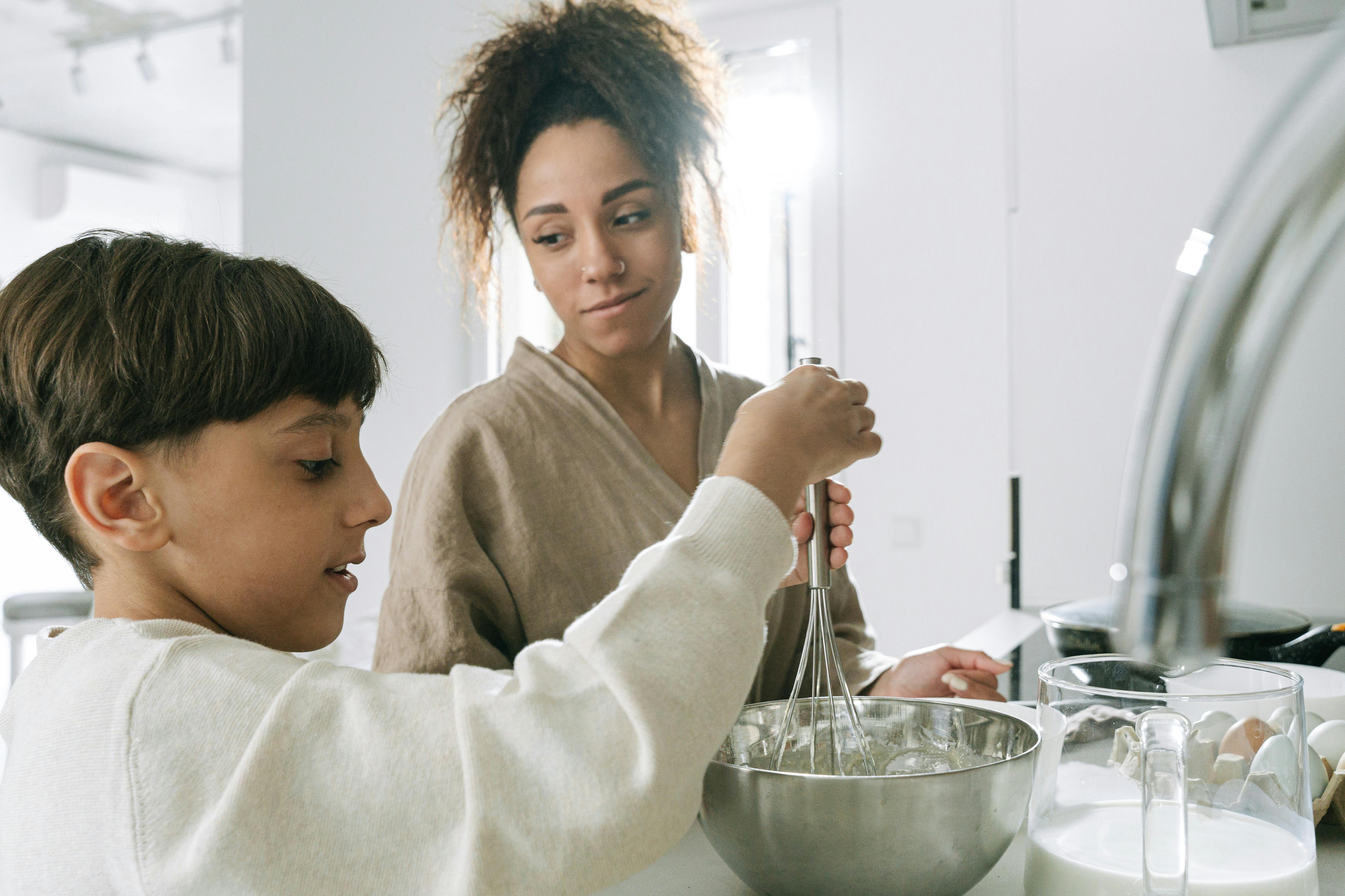 mother and son cooking at the kitchen