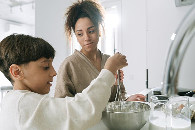 Mother And Son Cooking At The Kitchen