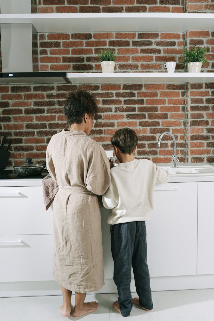 Mother And Son Cooking At The Kitchen