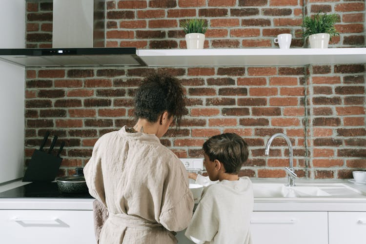 Mother And Son Cooking At The Kitchen