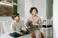 Man in Gray Sweater Sitting Beside Woman in Gray Sweater