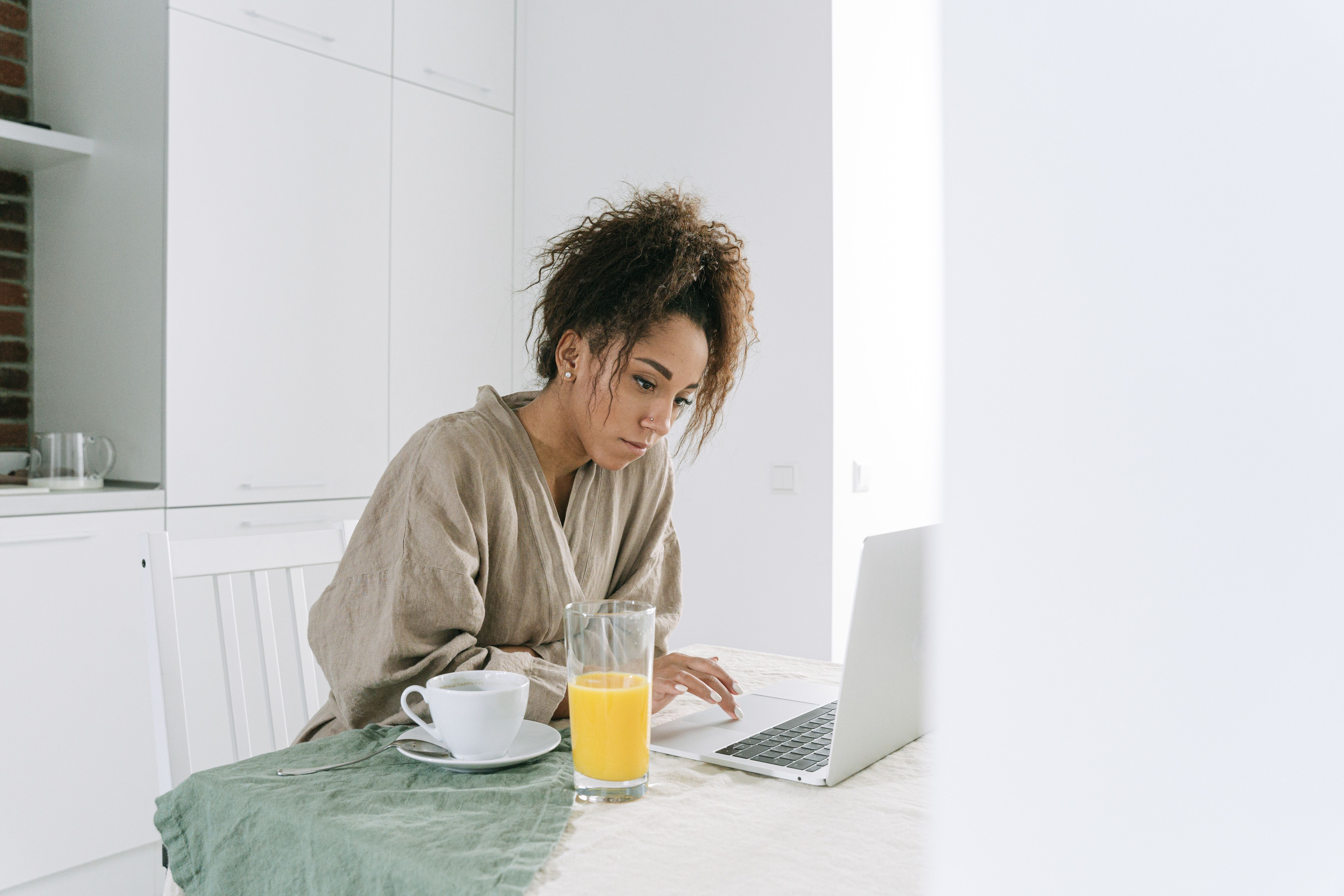 Woman in her late forties reviewing a telehealth GLP-1 medication plan on her laptop at home