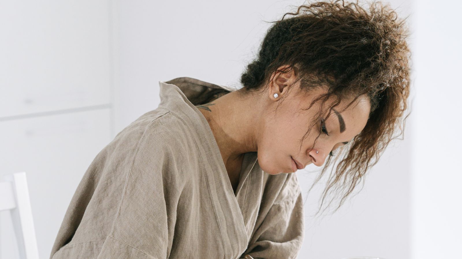 A woman writing in her journal during a peaceful morning with coffee