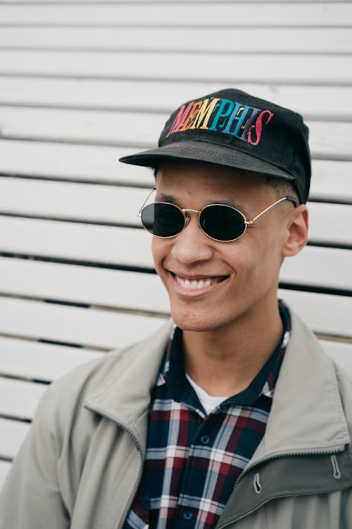 Smiling Man in Baseball Cap and Round Sunglasses