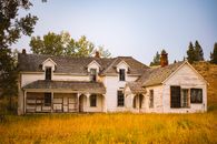 White and Brown House Near Green Trees Under White Sky