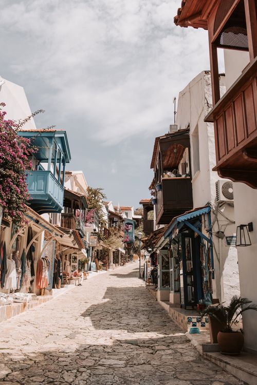 Free Beautiful sunny day in the historic cobblestone streets of Antalya, Turkey, featuring traditional architecture and vibrant market fronts. Stock Photo