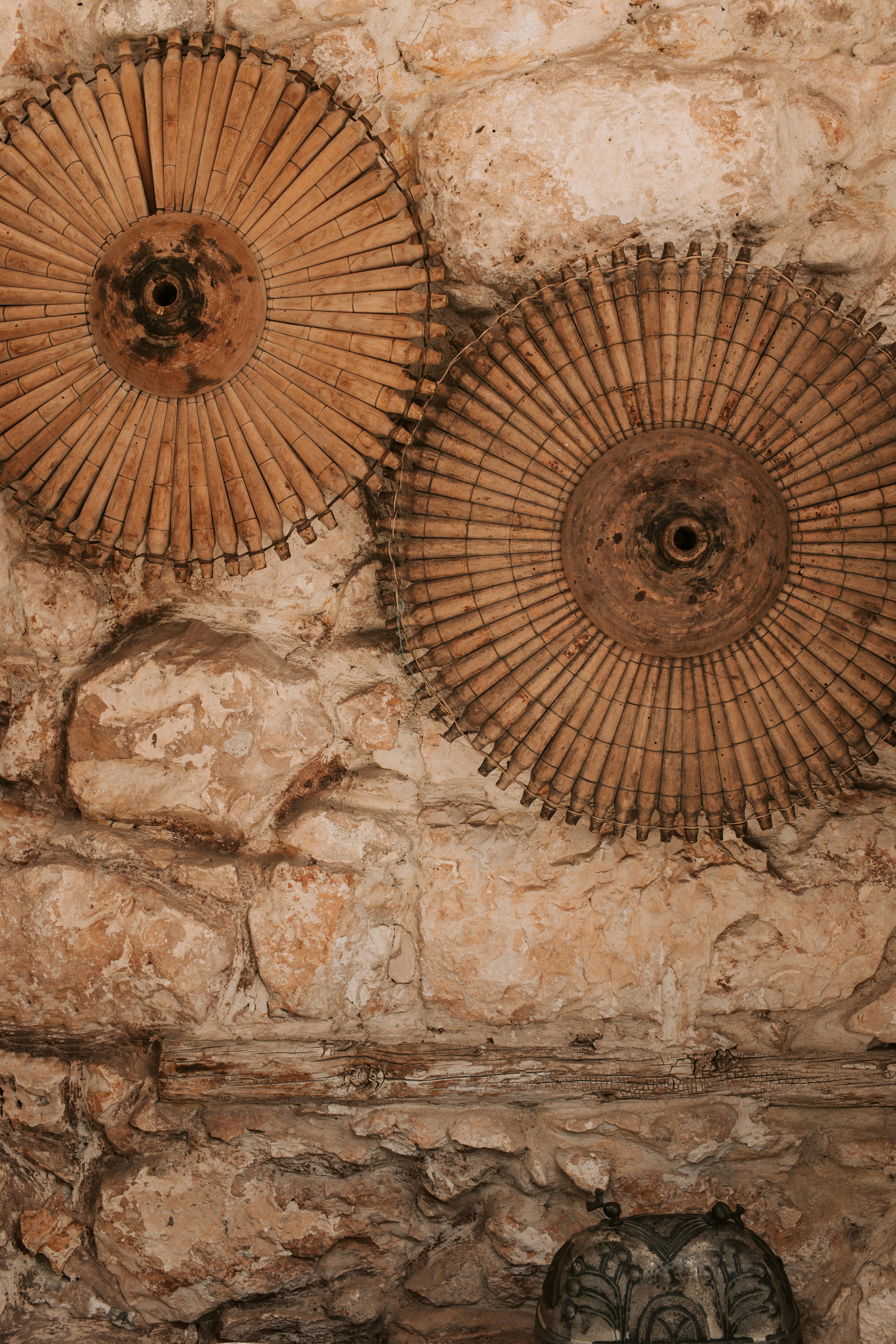 Artistic stone wall adorned with vintage circular decor, creating a rustic feel.