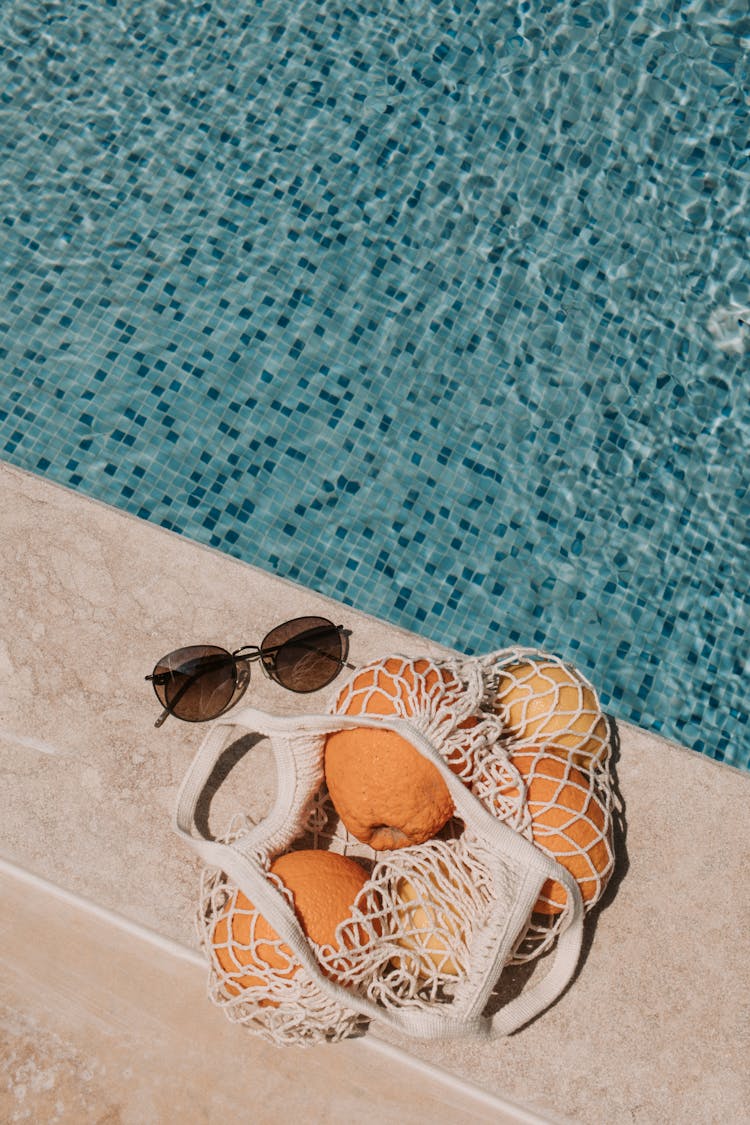  Basket Of Orange Fruits On Poolside