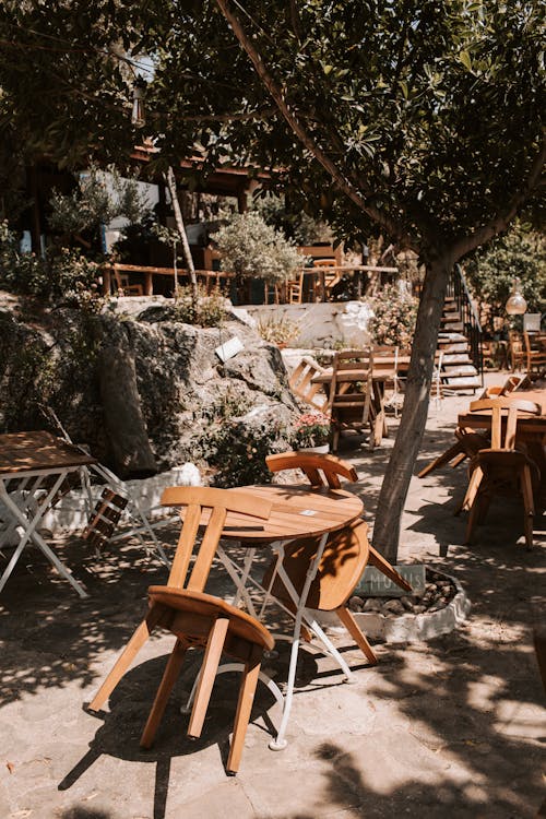 Wooden Chairs And Tables Outside A Restaurant