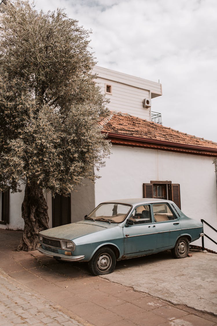 Vintage Car Parked Outside A House