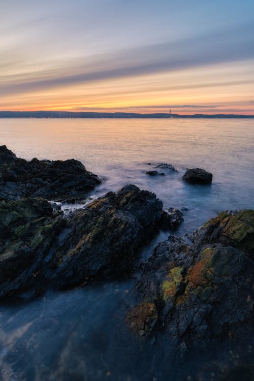 A Rocky Shore during a Twilight