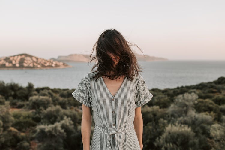 Woman Standing With Face Covered By Her Hair