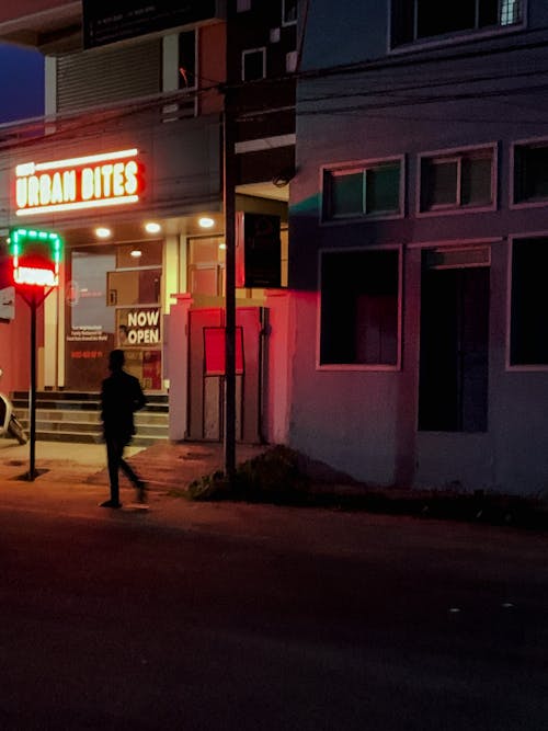 A Person Walking in Front of a Restaurant