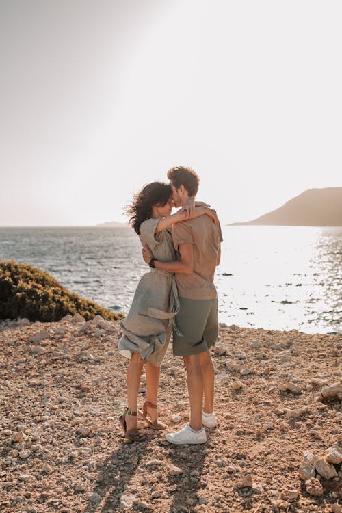 Free Romantic Couple Hugging By The Shore Stock Photo