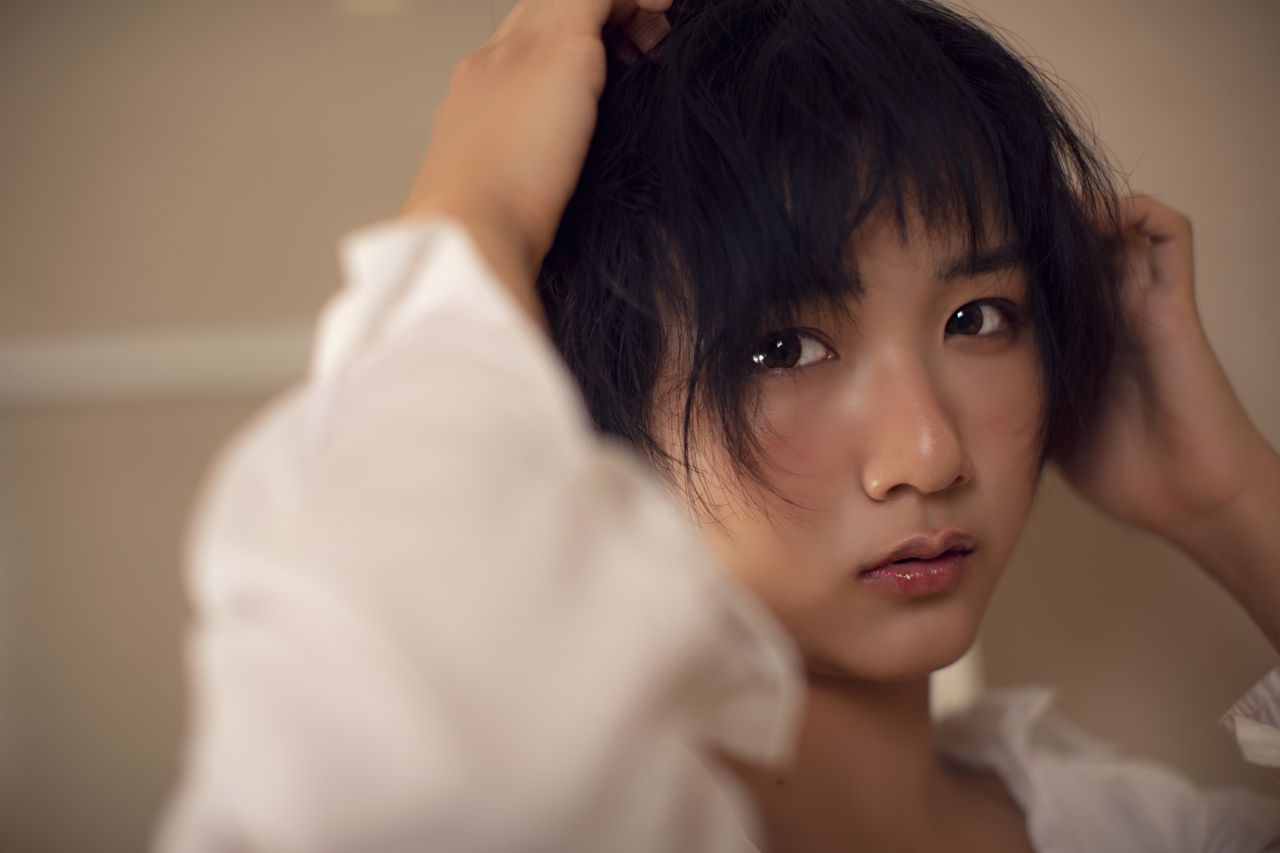 elegant portrait of a young asian woman with a minimalist background e